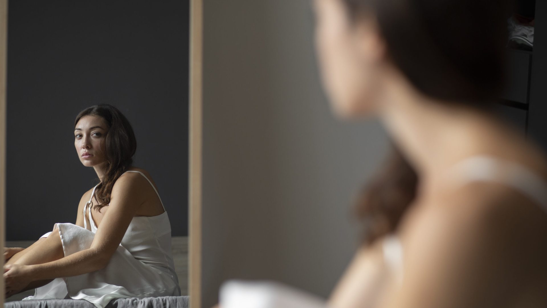 portrait-young-woman-with-low-self-esteem-with-mirror
